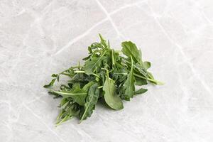 Green Arugula heap over background photo