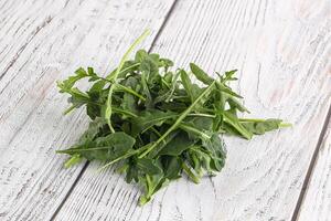 Green Arugula heap over background photo