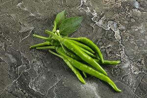 Spicy green chili pepper heap photo