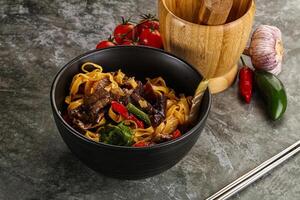 Asian wok with noodle, vegetables and beef photo