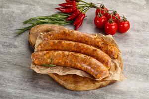 Raw sausages with spices and herbs photo