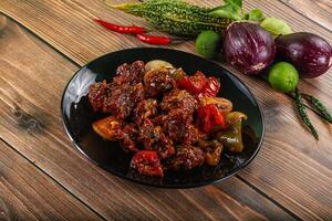 Asian cuisine - pork with chili sauce photo