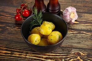 Boiled potato with oil and dill photo