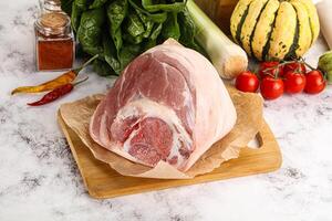 Uncooked raw pork knuckle with spices photo