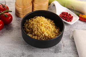 Boiled bulgur wheat in the bowl photo