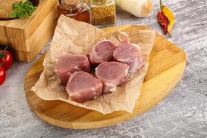 Uncooked raw pork tenderloin medallions photo