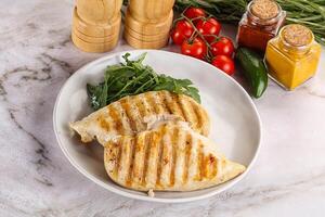 Grilled chicken breast served arugula photo