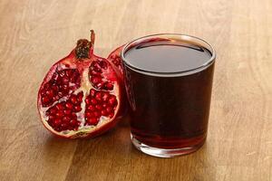 Sweet pomegranate juice in glass photo