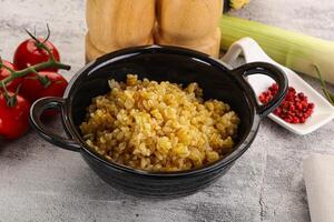 Boiled bulgur wheat in the bowl photo