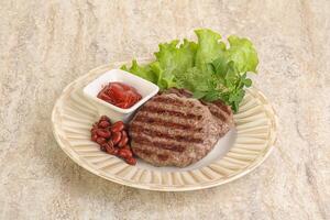 Grilled beef burger cutlet with sauce photo