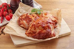 Marinated chicken leg in tomato sauce photo