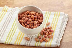 Raw peanut heap in the bowl photo