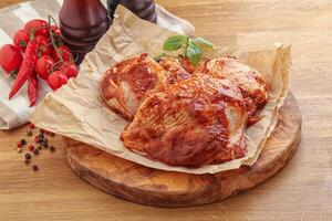 Marinated chicken leg in tomato sauce photo