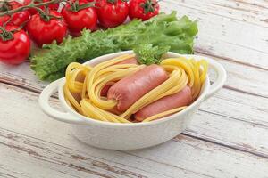 Mini sausages with pasta spaghetti photo