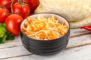 Fermented cabbage sauerkraut in the bowl photo