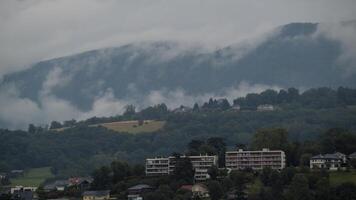 Misty mountain and buildings in Alps video