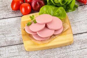 Slices boiled sausages for breakfast photo