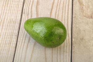 Ripe green avocado over background photo