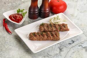 Kebab with beef served onion photo