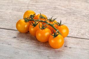 Ripe yellow cherry tomato branch photo