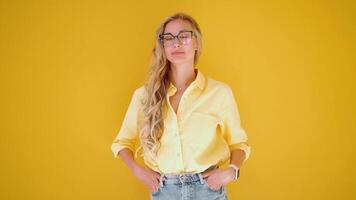 a woman with glasses smiles at the camera video