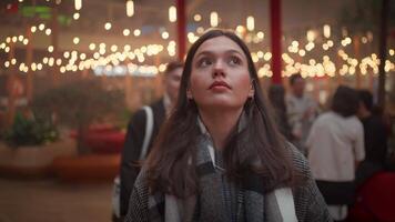 a woman looking up at the sky with lights in the background video