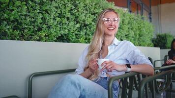 a woman in glasses holding a cup of coffee video