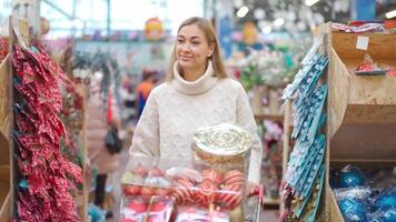 a woman with long blonde hair walking through a store video