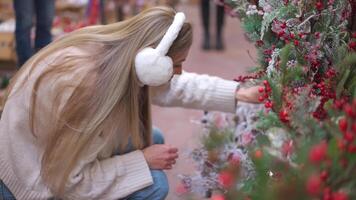 a woman with long blonde hair walking through a store video