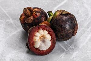 Tropical exotic purple sweet mangosteen photo