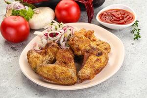 Grilled chicken wings with sauce photo