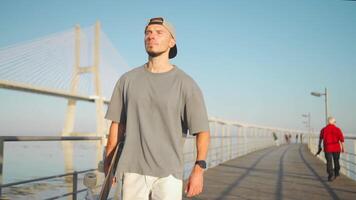 adult male person ride skateboard on bridge summer day. video