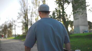 adulto masculino persona paseo patineta en ciudad parque verano día. video