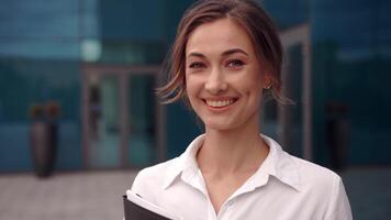 a woman in a business suit holding a folder video