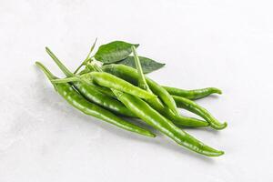 Spicy green chili pepper heap photo