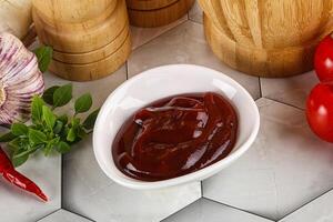 Tasty barbecue sauce in the bowl photo