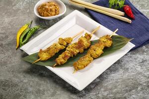 Thai meat skewer Satay with sauce photo