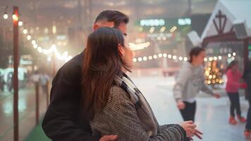 Cheerful young couple kissing and embracing on Christmas night. video