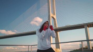 Woman shadow boxing with her hands wrapped in red boxing tapes video