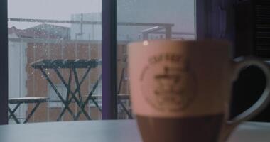 Rain On The Window While A Hot Coffee Sits On A Table Inside video