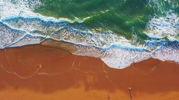 Aerial view of wave on the beach with sand and turquoise waves video