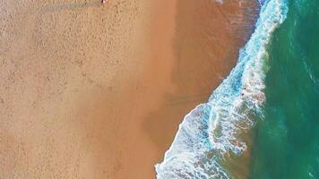 Aerial view of wave on the beach with sand and turquoise waves video