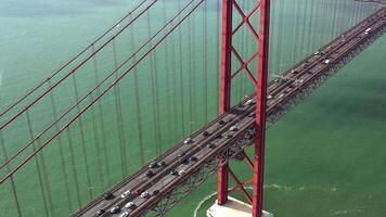Aerial view of traffic on 25 April bridge over the Tagus River in Lisbon Portugal. video