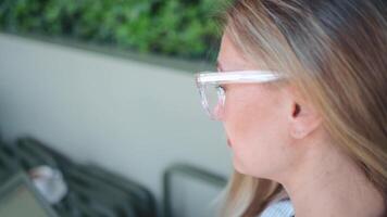 Portrait of a woman with glasses smiling towards the camera video