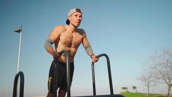 Male athlete engaged on sports ground outdoor in park. video