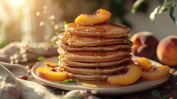 A stack of warm, fluffy pancakes topped with syrup and a fresh peach slice, glistening in sunlight photo