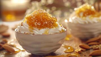 A bowl of yogurt with honey and almonds on a wooden table photo