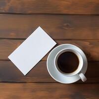 Business card mockup and a cup of coffee on a wooden background, top view. White namecard design mock up presentation photo