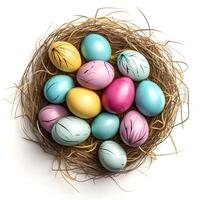 Colorful Easter eggs in nest from straw isolated on white background, top view photo