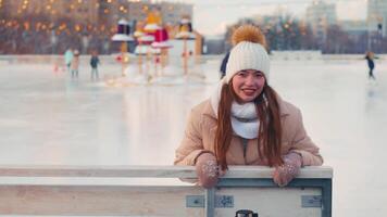 ung leende kvinna is skridskoåkning inuti på is rink. video